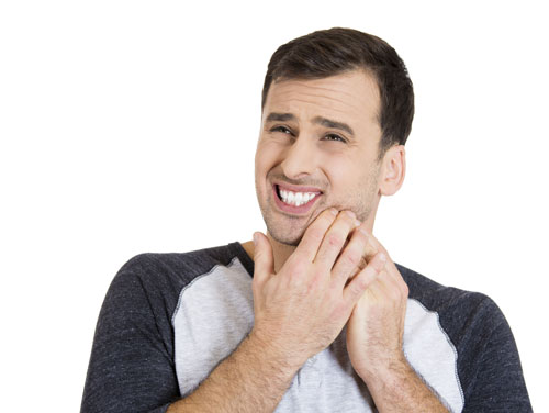 Man with cold sore holding jaw